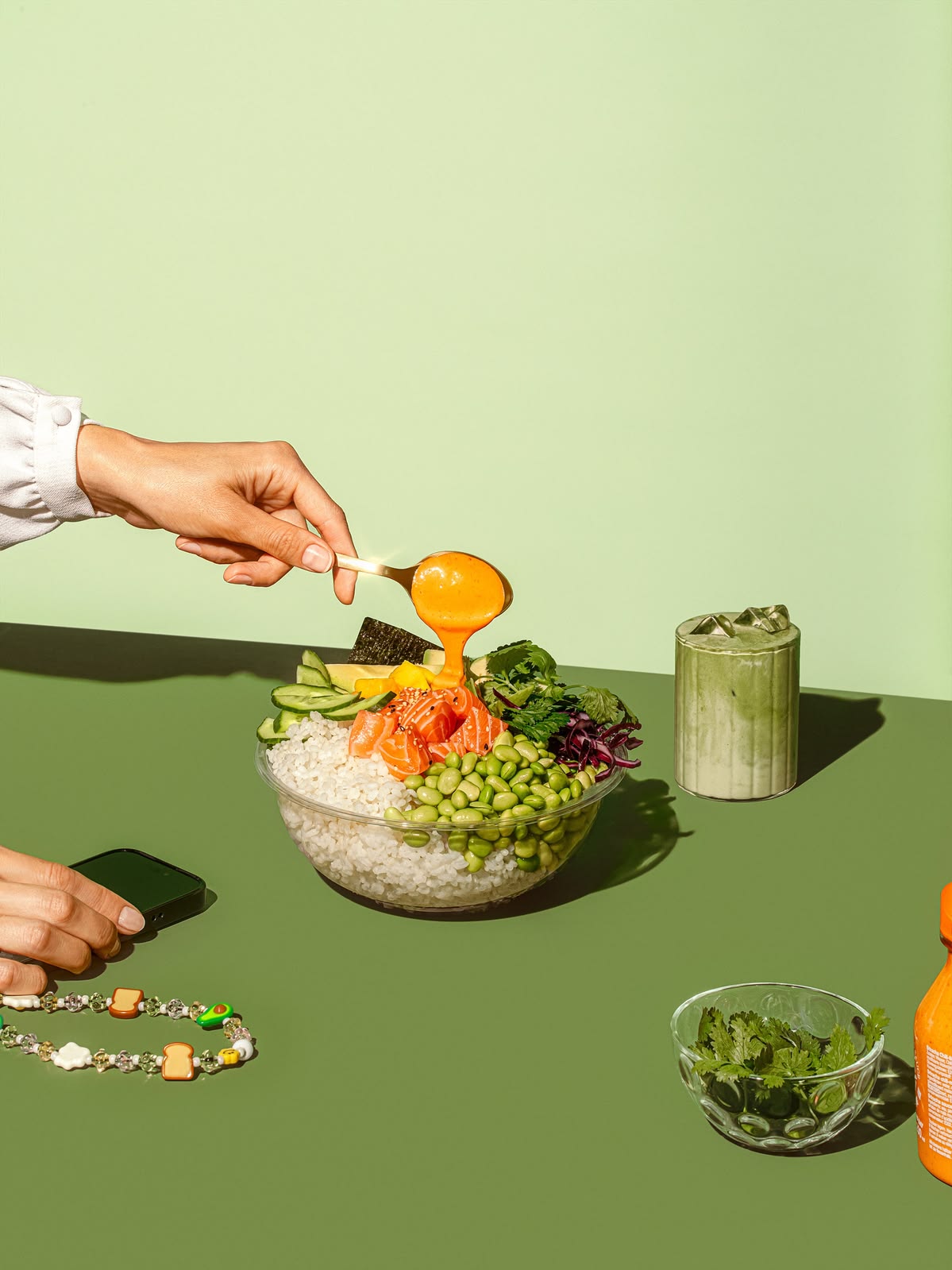 Salmon poke bowl with avocado, edamame and a green drink